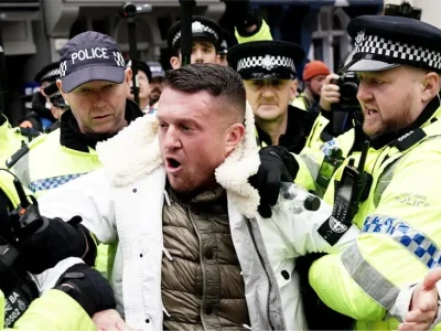 Tommy Robinson charged after attending antisemitism march in London